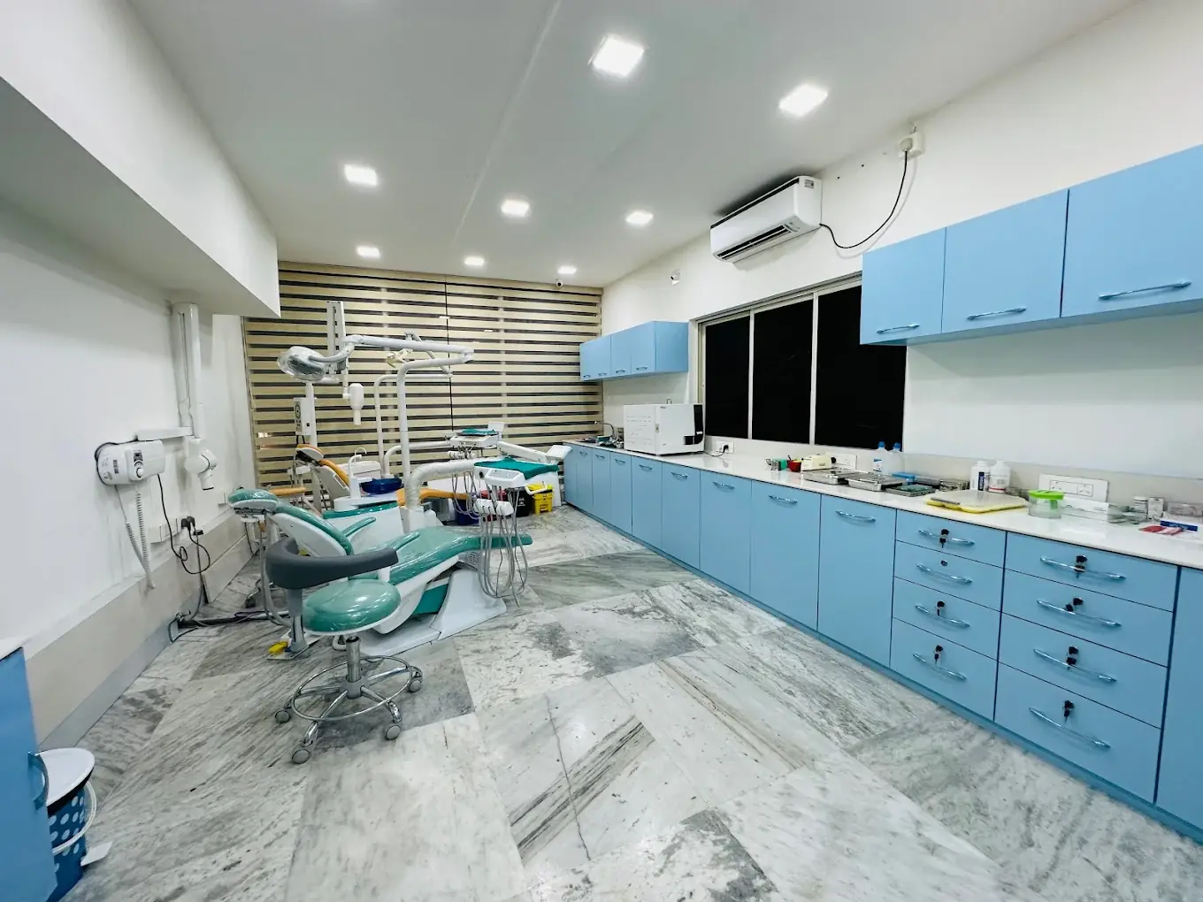 ZDentistry clinic interior with modern equipment and blue cabinets